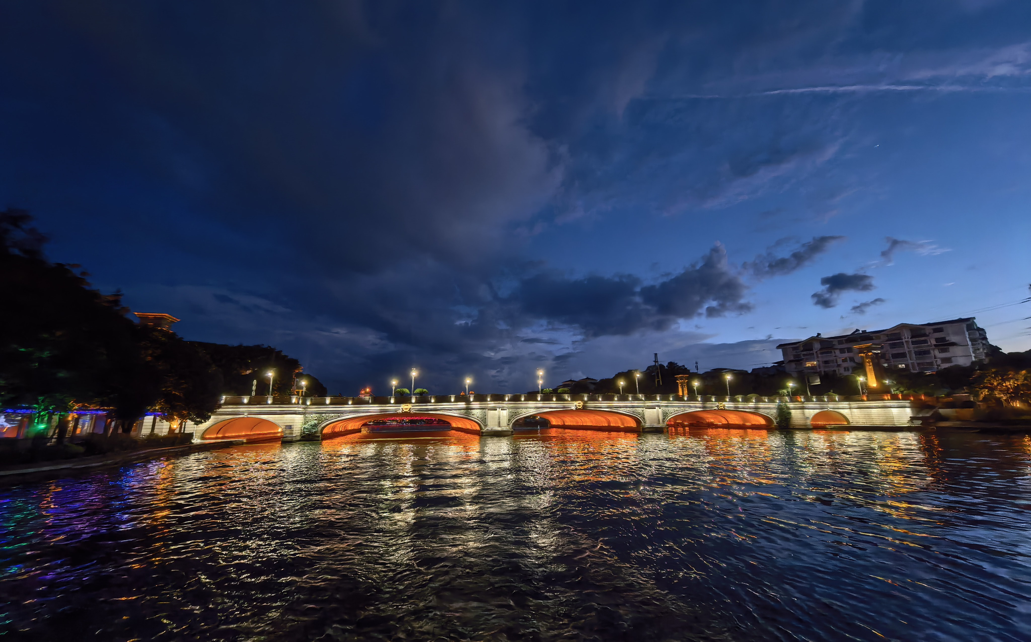 An illuminated bridge in Guizhou: a reminder that lasting connections depend on continuous care.